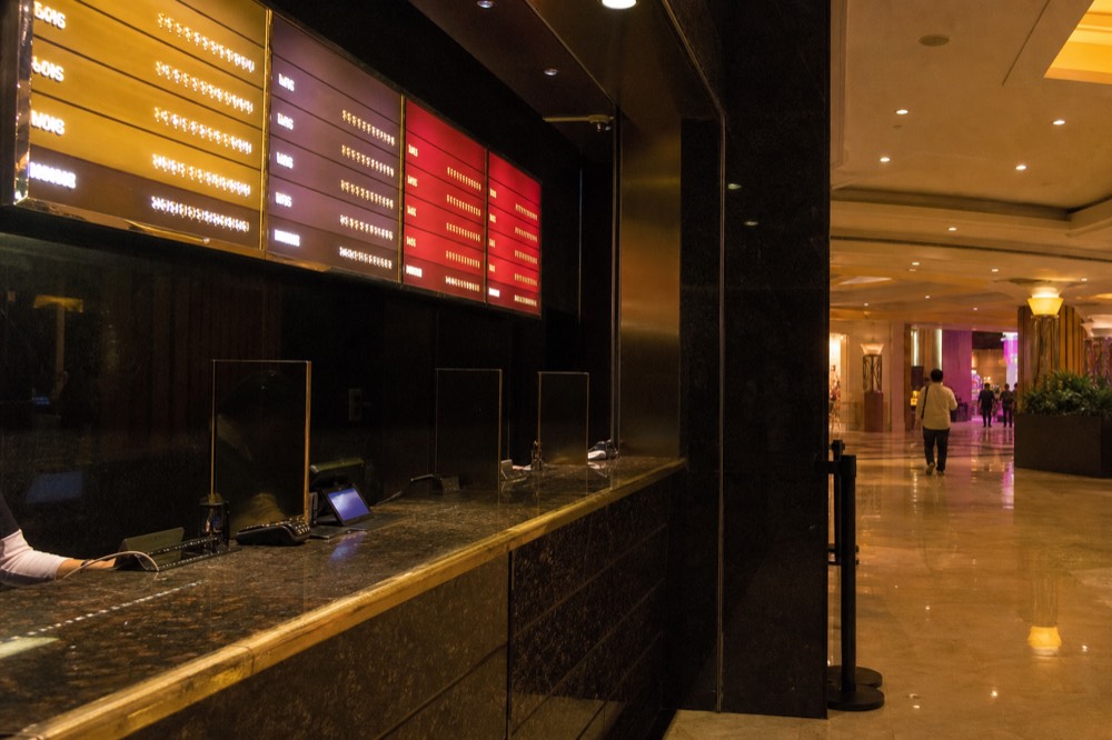 Theatre box office counter with ticket tiers displayed above