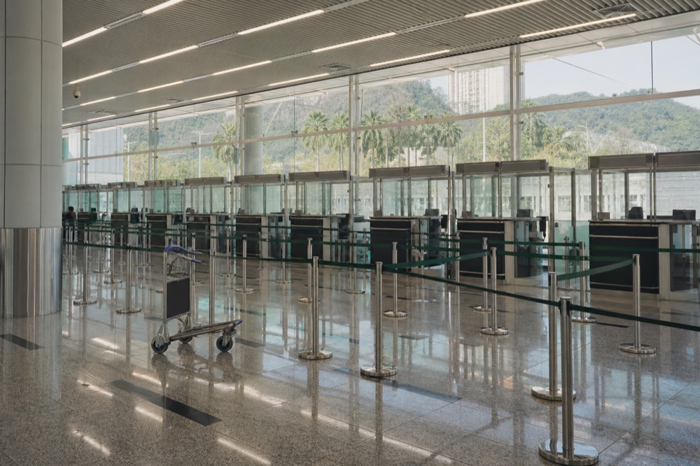 Rows of passport control booths in an empty immigration hall