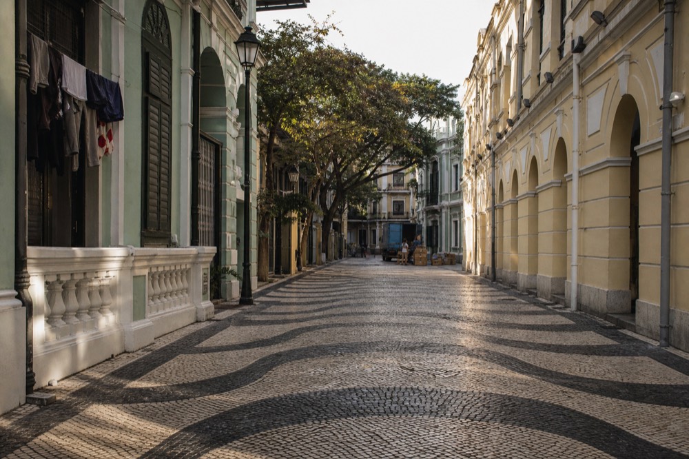 Historic Macau street with pastel colonial facades in morning light