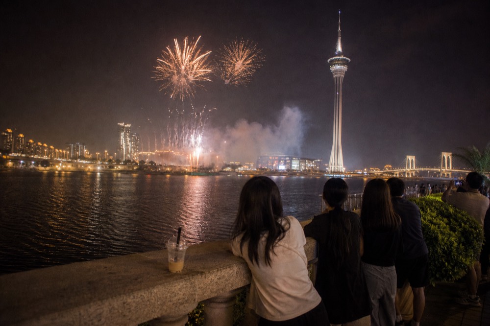 Evening fireworks bursting over Macau Tower and the waterfront