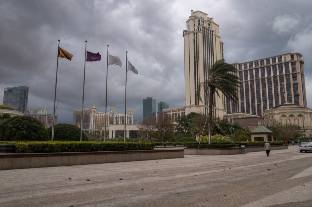 Storm clouds gathering over Cotai resort towers with flags lifting in wind