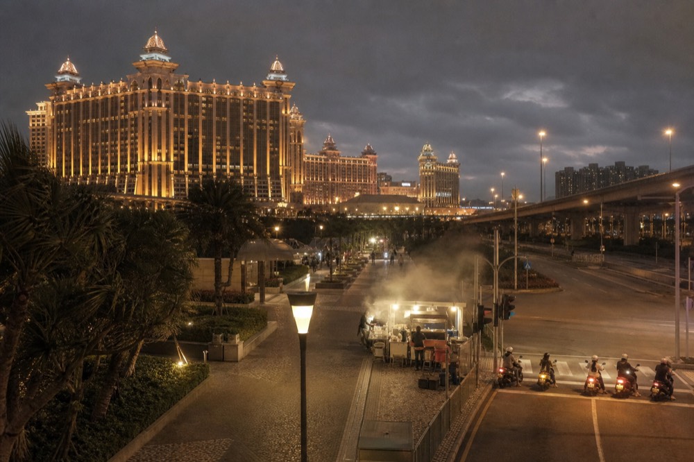 Wide evening view across Cotai with resort lights and a lit promenade
