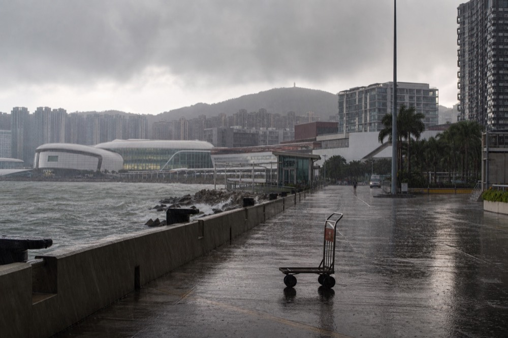 A harbour scene with gathering storm clouds over the water