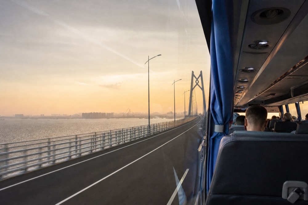 A shuttle bus on a long sea bridge crossing open water
