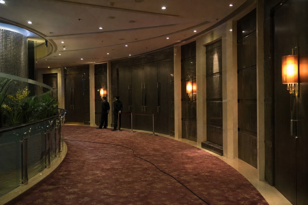 The theatre foyer walkway toward the entrance doors before an evening performance