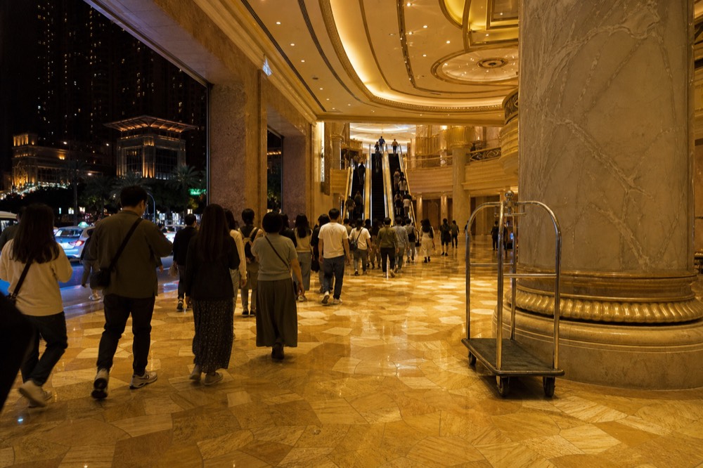 A crowded resort walkway after a performance as visitors stream toward exits