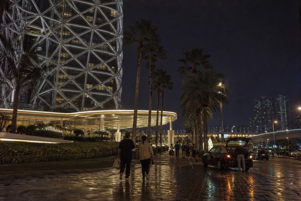 A lit resort facade and promenade in the Cotai area at night