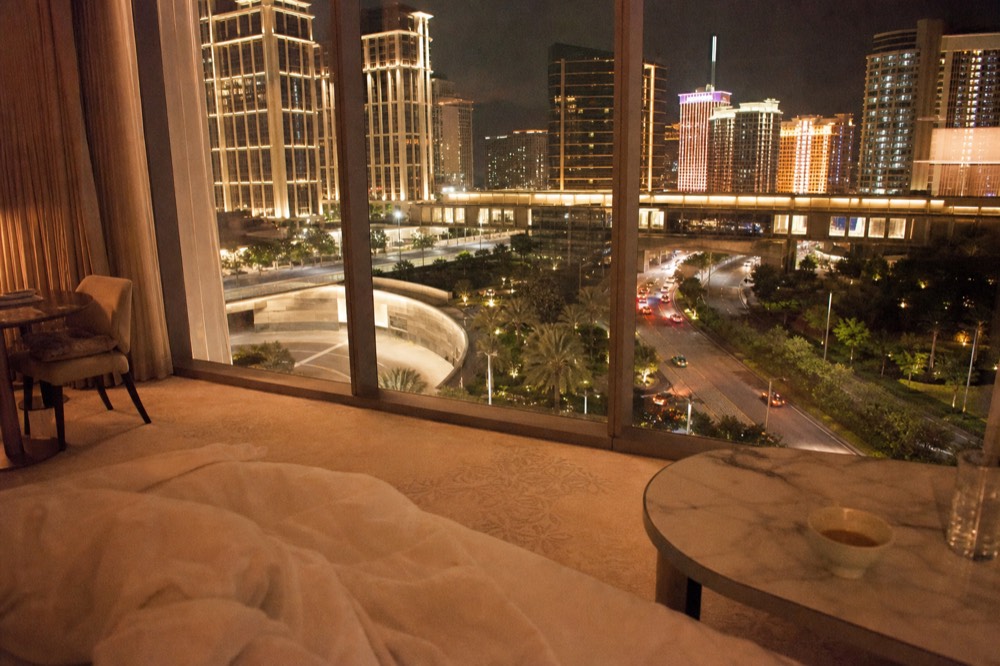 A luxury hotel suite interior with floor-to-ceiling windows over Cotai
